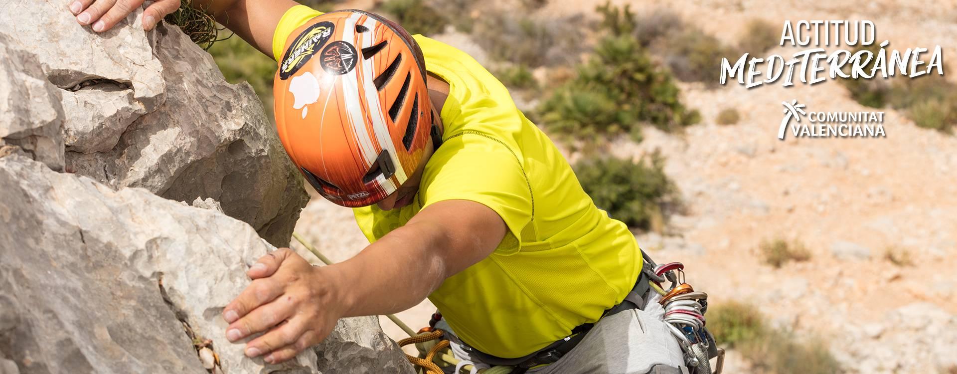 Young people zip-lining through mountain scenery	